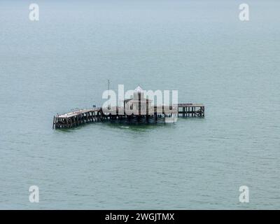 Surviving head of Herne Bay pier. Damaged by storms the old pavilion stands stranded at sea. Once provided a mooring for steam ships now derelict. Stock Photo