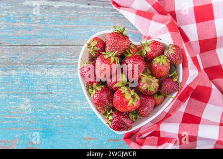 Ripe strawberries in a heart shaped bowl Stock Photo