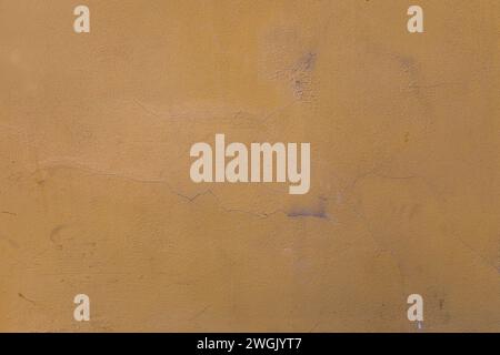 yellow orange  stucco wall, texture, peeling paint.background Stock Photo