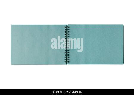Open spiral bound notepad with two craft turquoise sheets, isolated on white background. Top view, copy space for text, template, mockup Stock Photo