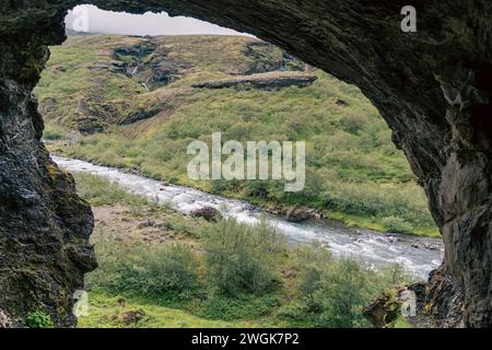 River as seen through the Pvottahellir Cave on the Glymur waterfall trail, Iceland Stock Photo