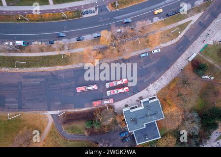 Drone photography of end bus station with parked bus in a city during autumn morning Stock Photo
