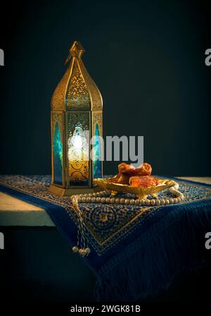 Traditional Ramadan lantern and rosary. Beautiful photo of Egyptian antique lantern with dates and rosary. Stock Photo