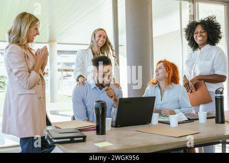 Multiethnic business colleagues smiling while enjoying time together at the office. Business concept. Stock Photo
