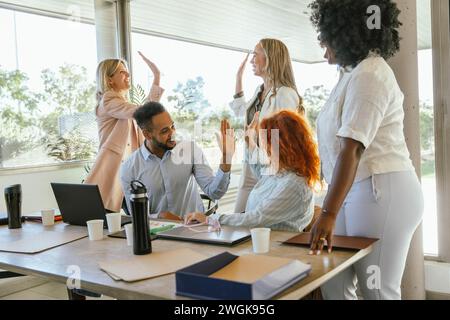Business colleagues celebrating success while working on a project together. Business concept. Stock Photo