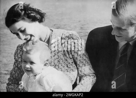 Photograph of a young Charles III seated on the lap of his mother, Elizabeth II, with his father, Prince Philip, seated beside them. This family portrait, likely taken in the early 1950s, shows the future King Charles III in his early childhood, alongside his parents before Elizabeth's ascension to the throne in 1952. The image captures a personal moment in the life of the royal family, before Elizabeth and Philip's roles as queen and consort were fully realized. Stock Photo