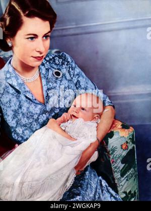 Portrait of Elizabeth II cradling her newborn daughter, Princess Anne, taken in 1950. This photograph captures the future queen with her second child, born on August 15, 1950. The image offers a glimpse into the early years of Elizabeth's family life, a period just before she began her reign in 1952. Stock Photo