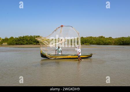 Cartagena, Colombia - 24 January 2024: Person using a traditional fishing net on the lagoon in a village in La Boquilla on the outskirts of Cartagena Stock Photo