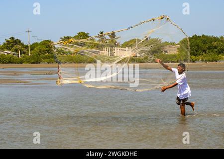 Cartagena, Colombia - 24 January 2024: Person using a traditional fishing net on the lagoon in a village in La Boquilla on the outskirts of Cartagena Stock Photo