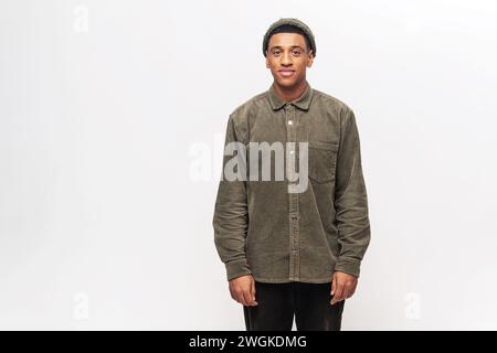 Portrait of cheerful young african-american guy wearing white casual shirt posing isolated on white background. Carefree young millennial man looking at camera and smiling Stock Photo
