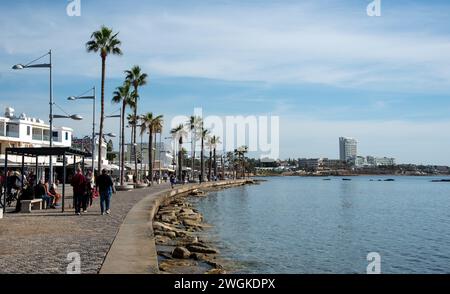 Tourist people walking at footpath in Kato Paphos holiday city resort in Cyprus, Europe. European destinations Stock Photo