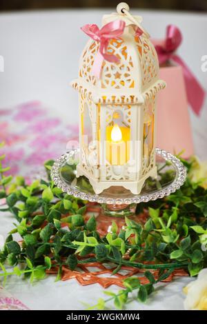 Islamic themed simple center table piece lantern paper and plastic green decorative foliage Stock Photo