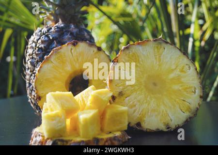 pineapple (Ananas comosus, Ananas sativus), whole fruit, pineapple slices and pineapple chunks on a table, fresh fruits Stock Photo