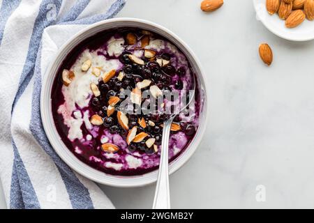 A yogurt bowl filled with healthy seeds and topped with blueberries and almonds. Stock Photo