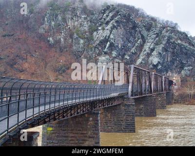 Railroad bridge and train tunnel over Potomac River and through Appalachian Mountains in Harpers Ferry, WV, in the winter. Stock Photo