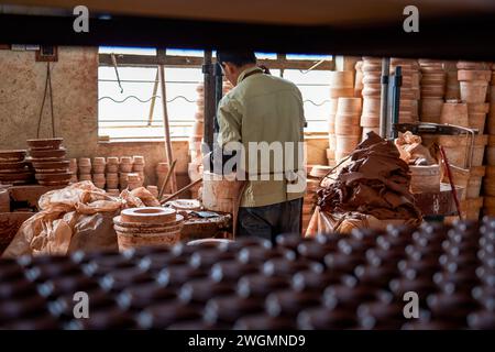 A craftsman makes porcelain in a traditional Chinese porcelain factory Stock Photo