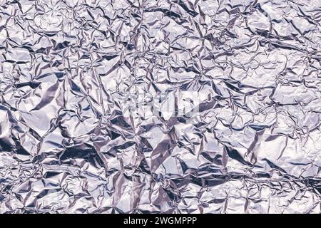 Crumpled aluminum tin foil texture as background, top view Stock Photo