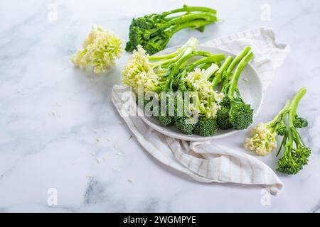 Fresh raw green bimi, broccolini and baby stick cauliflower in a bowl Stock Photo