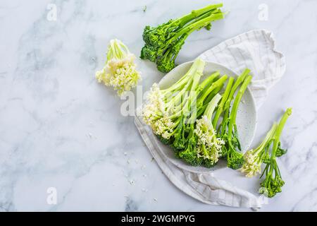 Fresh raw green bimi, broccolini and baby stick cauliflower in a bowl Stock Photo