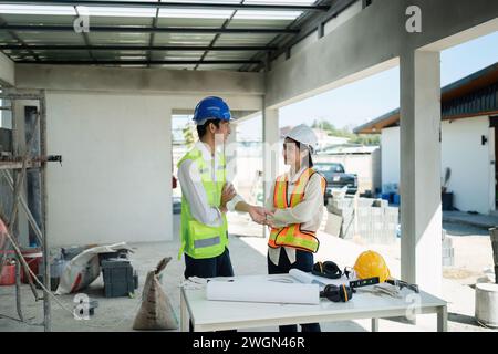 team engineer, foreman, architect meeting for colleagues discussing and checks construction blueprints at onsite Stock Photo