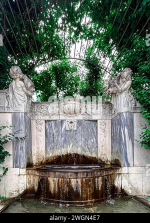 Step into serenity at Volksgarten's mossy fountain, where nature's embrace meets Vienna's elegance. A tranquil haven amidst the city's bustling charm. Stock Photo