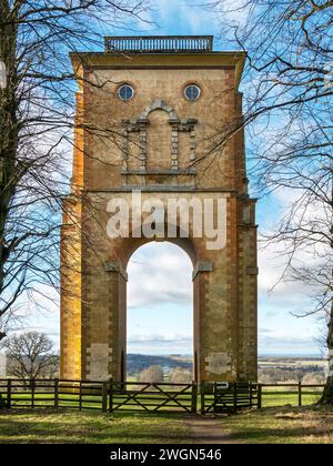 View through the single arch of Bellmount Tower down the tree lined avenue to Belton House, Grantham, Lincolnshire, England, UK Stock Photo