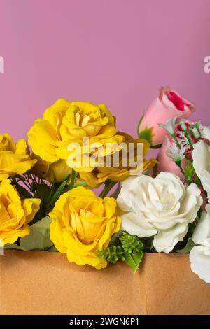 Beautiful bouquet of yellow and white roses on a pink background. Stock Photo