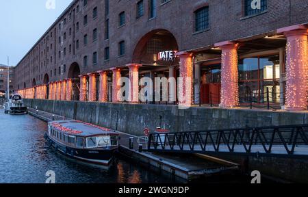 Tate Liverpool Art Gallery sign lit up at night at Albert Dock, Liverpool, Merseyside, Stock Photo