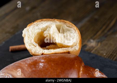 such a bun in jam on the table, a half-broken bun for tea Stock Photo