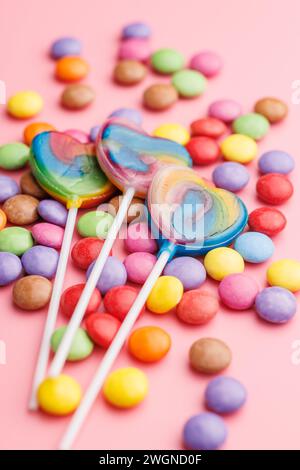 Colorful sweet jelly candies and lollipops. Sweet candies on the pink background. Stock Photo