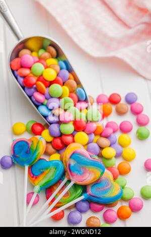 Colorful sweet jelly candies and lollipops. Sweet candies on the white table. Stock Photo