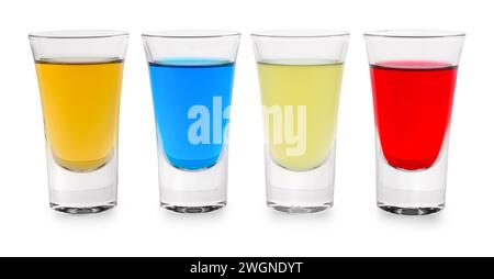 Different shooters in shot glasses isolated on white. Alcohol drink Stock Photo
