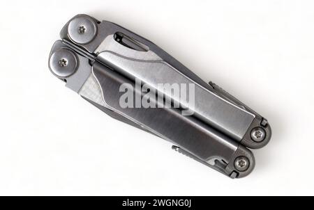 Folded steel multitool isolated on white background, top view. A tool for daily practice. All in one. Construction and repair. Compact and portable pr Stock Photo