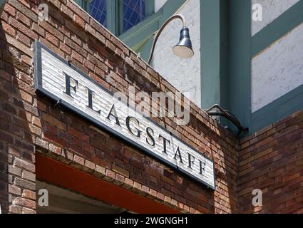 painted Flagstaff Arizona town sign on rustic brick wall Stock Photo