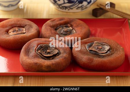 Plate with dried sweet kaki persimmon fruit close up Stock Photo