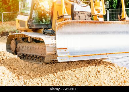 Roadworks and bulldozer levelling stone on top of geogrid plastic mesh Stock Photo