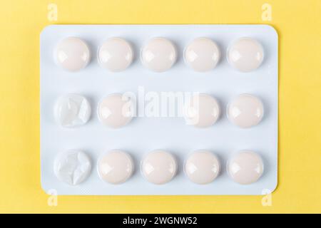 medicine blister packs viewed from above with two tablets missing. Stock Photo