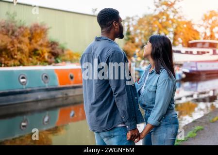 couple walking and hugging on the quays, pier,   looking at yacht, sailboat, boat, having a fun, date.  Lifestyle concept Stock Photo
