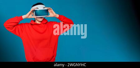 female in modern VR headset exploring virtual reality universe on futuristic blue background Stock Photo