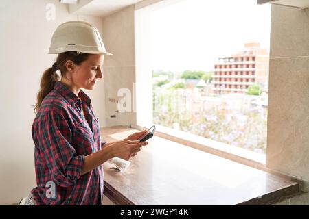 Young female contractor using tablet PC Stock Photo
