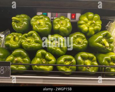 green peppers at vegetable rack in supermarket Stock Photo