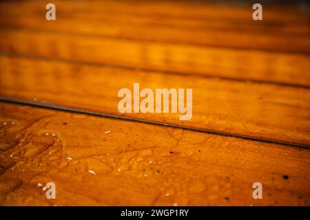 Close up of raindrops on the wooden floor Stock Photo