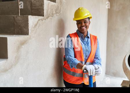 Smiling young mason wearing safety workwear Stock Photo