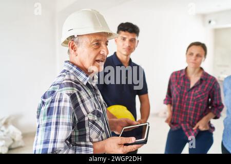 Senior architect discussing with workers Stock Photo