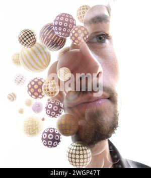 A double exposure close-up portrait of a young man combined with 3D spheres. Stock Photo