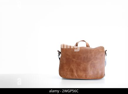 Brown fake leather men's messenger bag, isolated on white. Stock Photo