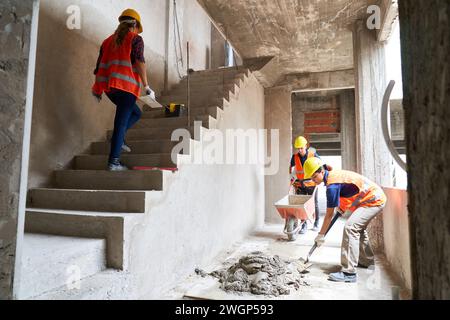 Young construction workers working together Stock Photo