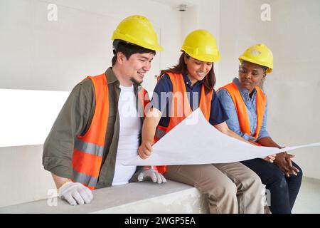 Diverse coworkers discussing and analyzing blueprint Stock Photo