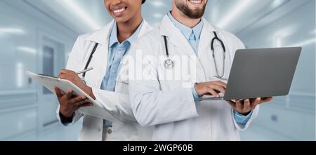 A cheerful man and woman medical team collaborating in a hospital Stock Photo