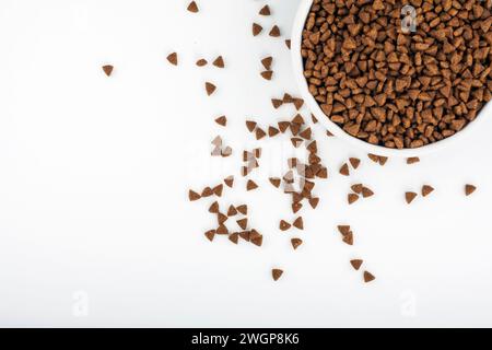 Dry pet food in a bowl isolated on white background Stock Photo